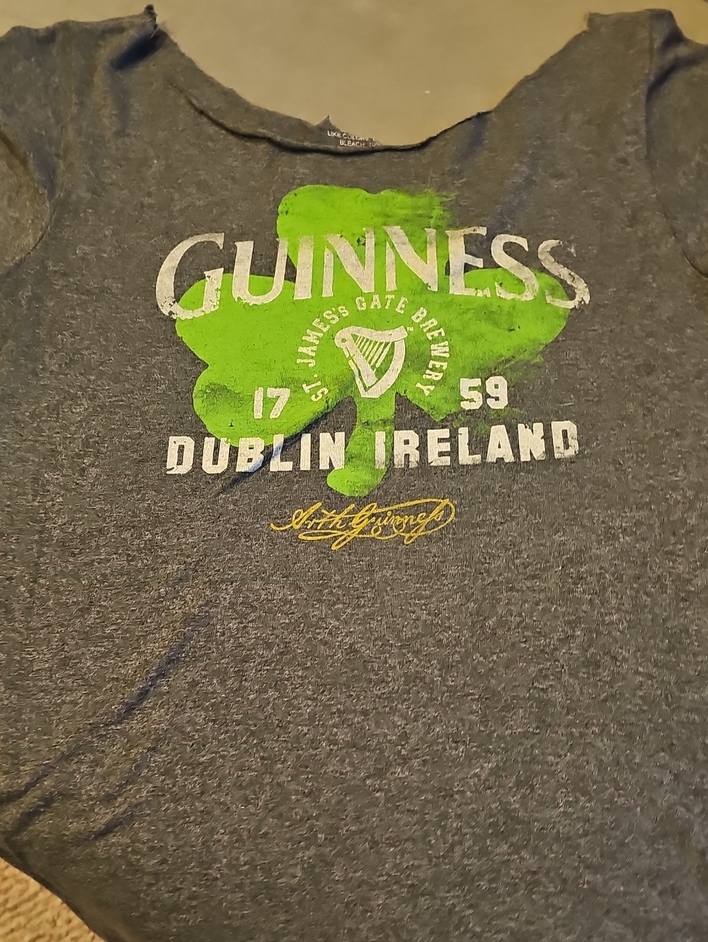 Guinness Gray Off Shoulder Tee with Green Shamrock and White Logo
